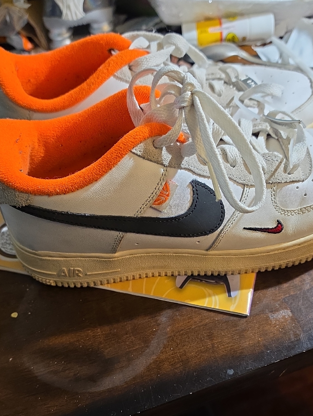Nike White Sneakers with Black Swoosh and Bright Orange Liner